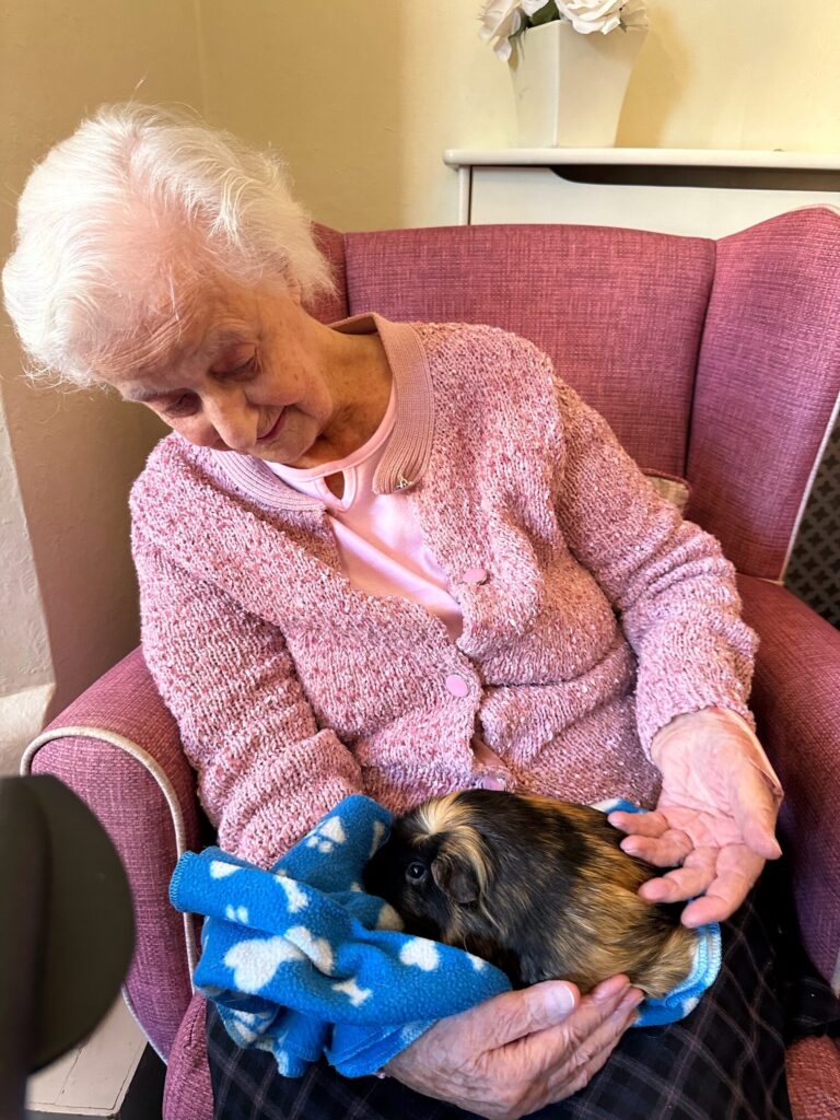 Resident holding a guinea pig