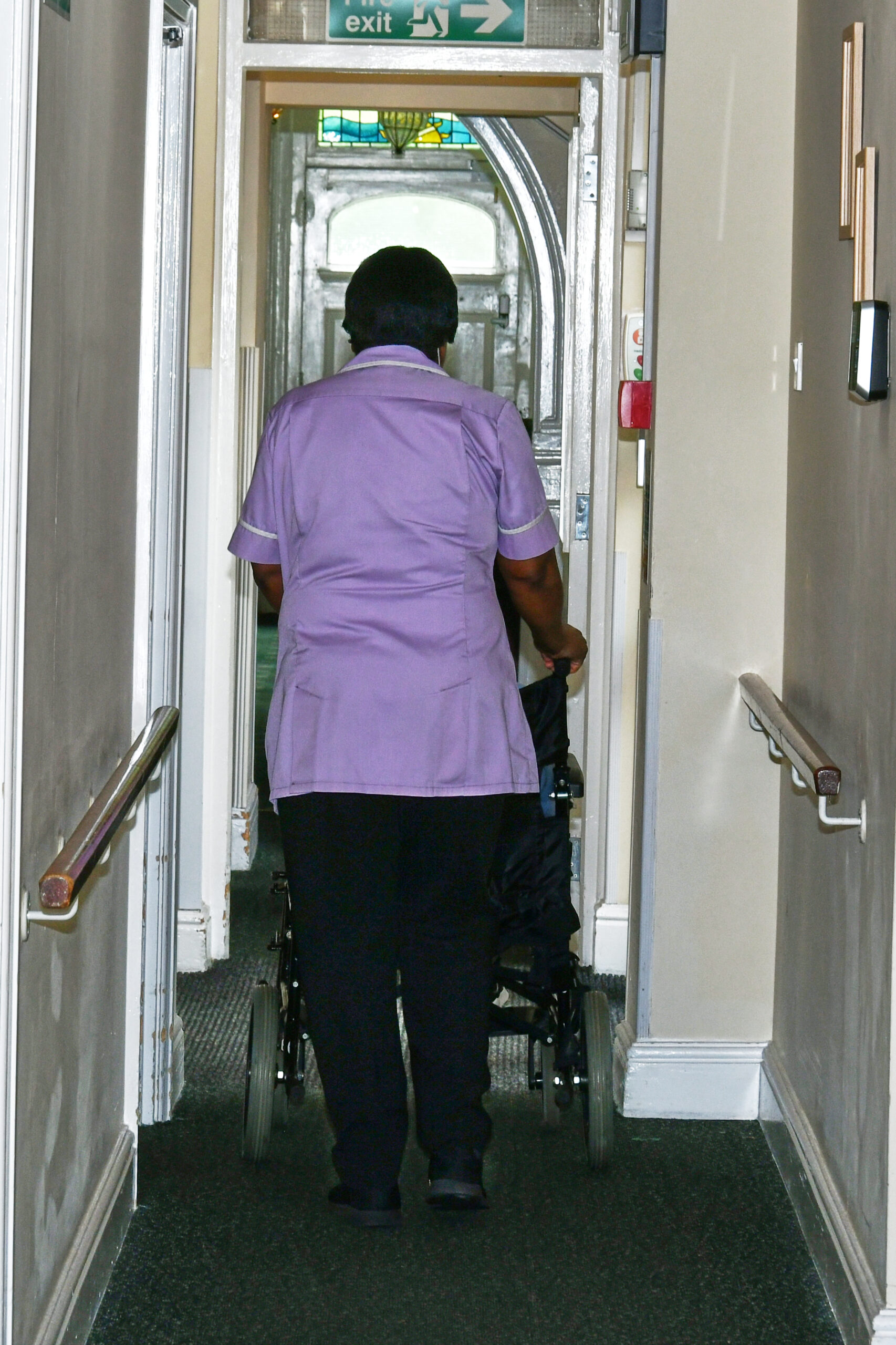 A resident is moved in a wheelchair