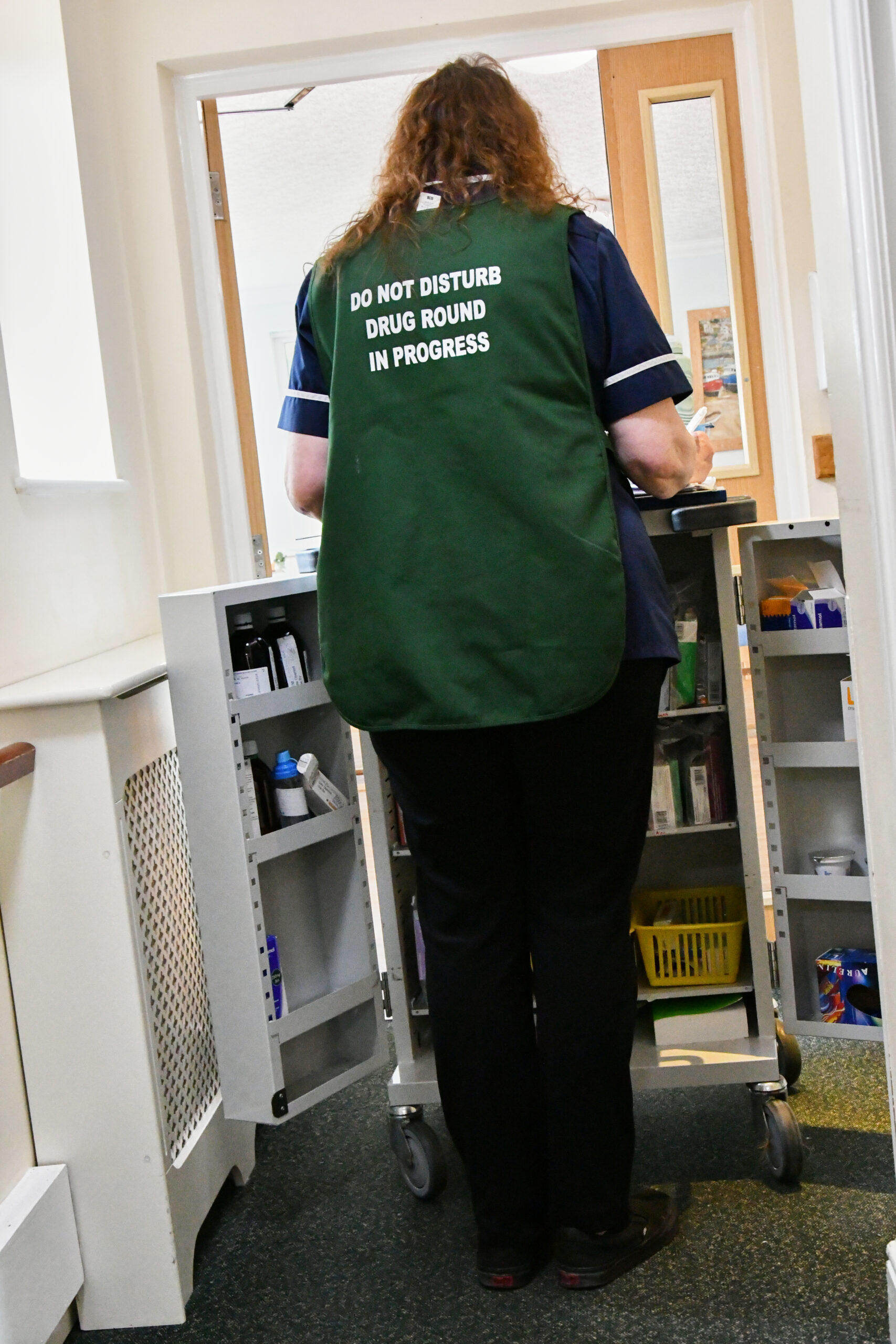Senior careworker on the medication round