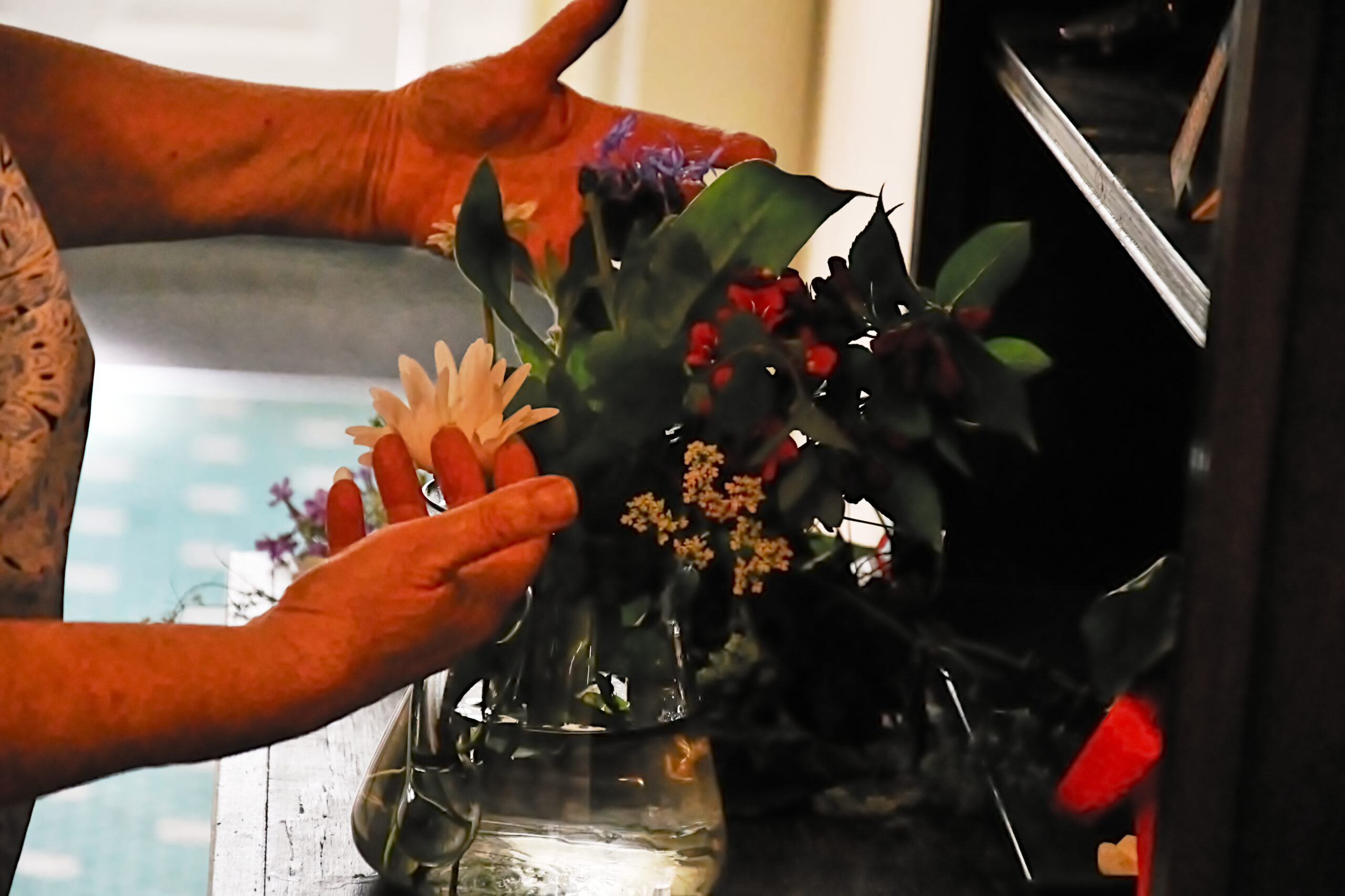 A resident arranges flowers from the garden